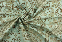 Load image into Gallery viewer, Novodari is a multi use fabric featuring a modern paisley and floral design in brown, taupe, cream and aqua blue.  It can be used for several different statement projects including window accents (drapery, curtains and swags), decorative pillows, hand bags, bed skirts, duvet covers, upholstery and craft projects.  It has a soft workable feel yet is stable and has a durability rating of 15,000 double rubs.
