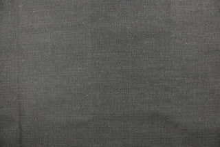  A mock linen in a weave design in gray and black  with a light backing. 