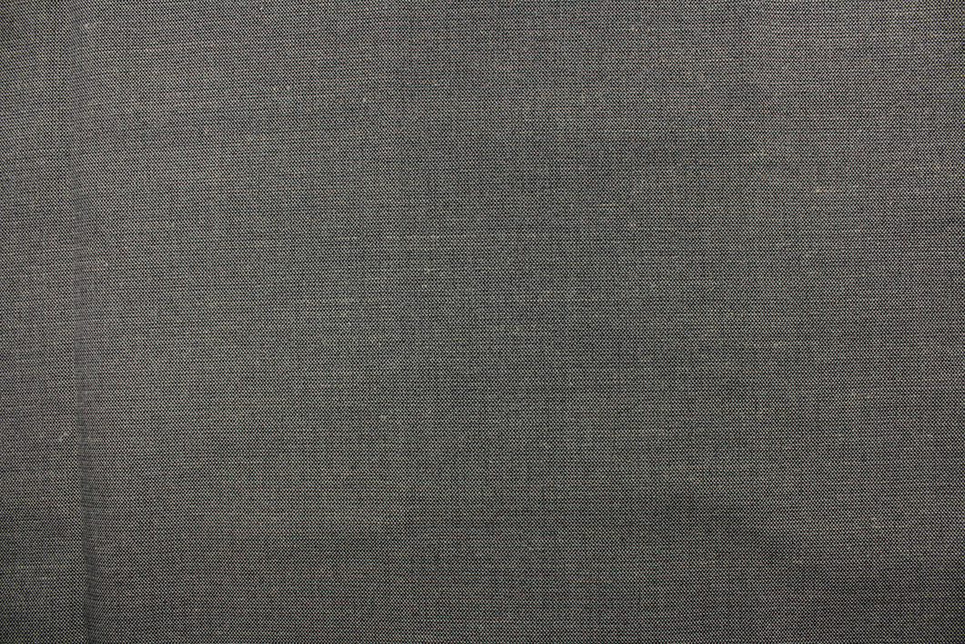 A mock linen in a weave design in gray and black  with a light backing. 