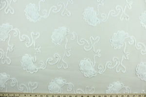 This fabric features a beautiful embroidered scroll line with embossed roses.  The sheer fabric is see through with a nice flowy drape.  It is perfect for special occasion apparel, costumes, overlays, table tops, décor, sheer curtains and more.  