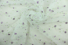 Load image into Gallery viewer, This fabric features a beautiful embroidered floral vine design in shades of purple and green against a white background.  The sheer fabric is see through with a nice flowy drape.  It is perfect for special occasion apparel, costumes, overlays, table tops, décor, sheer curtains and more.  
