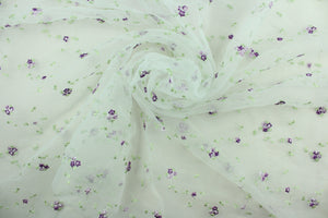 This fabric features a beautiful embroidered floral vine design in shades of purple and green against a white background.  The sheer fabric is see through with a nice flowy drape.  It is perfect for special occasion apparel, costumes, overlays, table tops, décor, sheer curtains and more.  