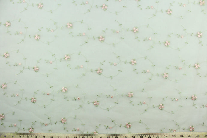 This fabric features a beautiful embroidered floral vine design in pink and green against a white background.  The sheer fabric is see through with a nice flowy drape.  It is perfect for special occasion apparel, costumes, overlays, table tops, décor, sheer curtains and more.  