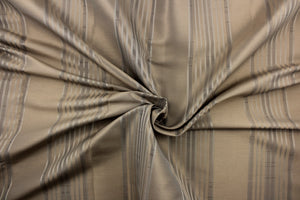 This light weight  fabric offers a formal feel. Featuring a  vertical striped pattern  in colors of taupe with a  slight sheen to enhance the rich colors and overall design. 