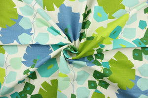 This fabric features a bold floral design in green, blue, light turquoise , teal and dull white. 