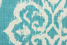Load image into Gallery viewer, This fabric features an ikat damask design in a beautiful Caribbean blue and a dull white. 
