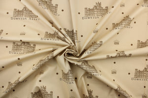 Featuring the downtown abbey building and wording in brown and black with brown dots against a tan background. 