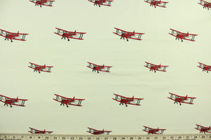 This cute and fun fabric features vintage biplanes embroidered in red and gray against a light beige background. Uses include drapery, pillows, light upholstery, table runners, bedding, headboards, home décor and apparel.  