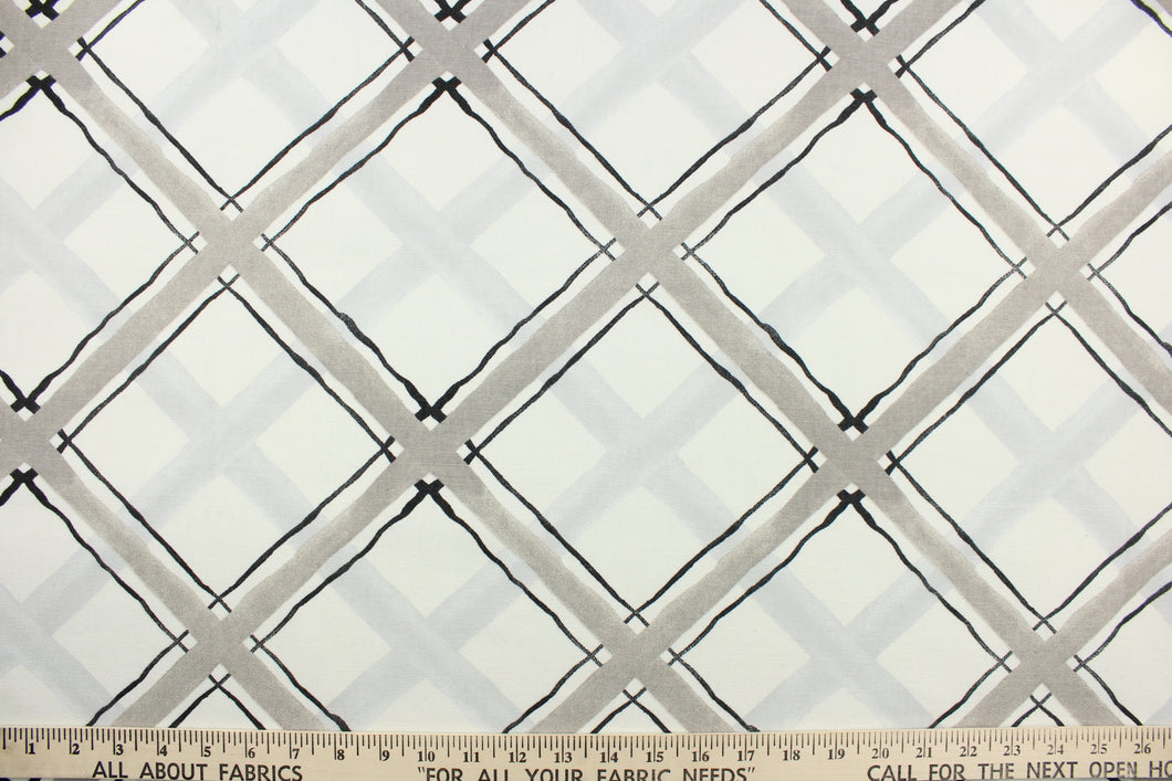 This fabric features a diagonal plaid design in black and gray against a white background .