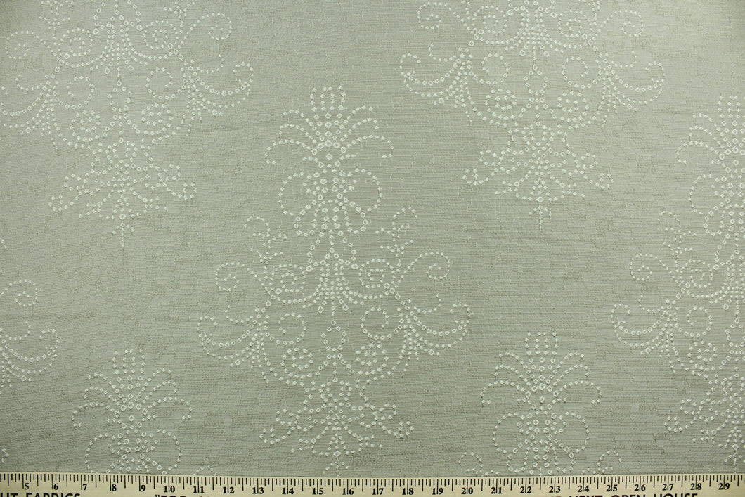 Steel Imprints features a large scale embroidered medallion design in gray.  The embroidered design adds an elegant look to the fabric.  Uses include apparel, decorative pillows, window treatments and bedding.