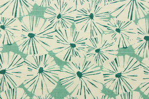 This fabric features a floral design in a dull white and a rich green against a light green. 