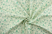 Load image into Gallery viewer, This fabric features a floral design in a dull white and a rich green against a light green. 
