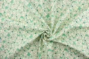 This fabric features a floral design in a dull white and a rich green against a light green. 