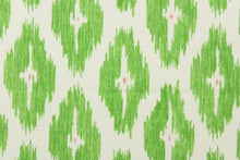 Load image into Gallery viewer,  This geometric medium scale ikat design in bright green with pink against a dull white . 
