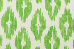  This geometric medium scale ikat design in bright green with pink against a dull white . 