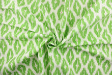 Load image into Gallery viewer,  This geometric medium scale ikat design in bright green with pink against a dull white . 
