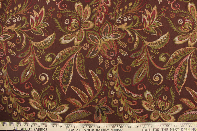 This tapestry features a floral design in gold, green, burgundy, and brown. 