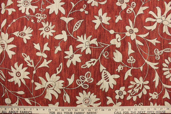 This simple, pretty floral design in beige or tan against a cayenne red background 