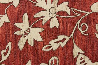 This simple, pretty floral design in beige or tan against a cayenne red background 