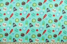 Load image into Gallery viewer, This cheerful holiday print features pretty ornaments outlined in a silver metallic overlay on a turquoise background.   The versatile lightweight fabric is soft and easy to sew.  It would be great for quilting, crafting and sewing projects.  Colors included are red, blue, green and dark gray.
