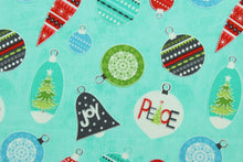 Load image into Gallery viewer, This cheerful holiday print features pretty ornaments outlined in a silver metallic overlay on a turquoise background.   The versatile lightweight fabric is soft and easy to sew.  It would be great for quilting, crafting and sewing projects.  Colors included are red, blue, green and dark gray.
