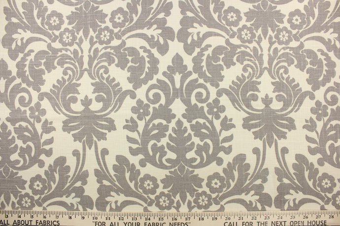 This fabric features a demask design in gray against a natural background .