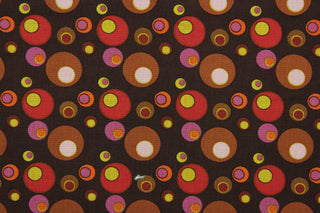 This screen printed fabric features vintage bubbles in shades of brown, pink, red, purple, yellow and orange against a dark brown background.  The versatile lightweight fabric is soft and easy to sew.  It would be great for quilting, crafting and sewing projects.  