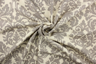 This fabric features a demask design in gray against a natural background .