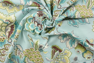 This fabric features a floral design in green, gray, cream, light blue, brown, and turquoise.