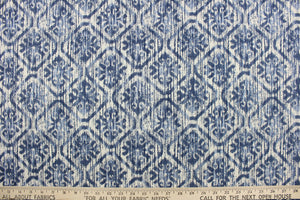 This fabric features an ikat diamond design in blue tones against a dull white .