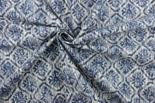 Load image into Gallery viewer, This fabric features an ikat diamond design in blue tones against a dull white .
