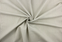 Load image into Gallery viewer, This fabric features a vertical ticking stripe design in a gray color against a dull white. 
