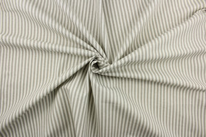 This fabric features a vertical ticking stripe design in a gray color against a dull white. 