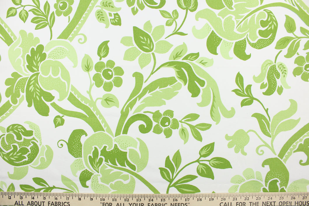  This fabric features a  large floral vine design with simple colors in varying shades of green flowers on a white background. 