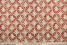Load image into Gallery viewer, This fabric features a floral design in beige and tan against a cayenne red with a slight distress look .
