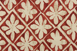 This fabric features a floral design in beige and tan against a cayenne red with a slight distress look .