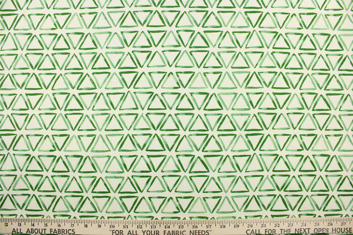 This fabric features a triangle design in green against a dull white background.