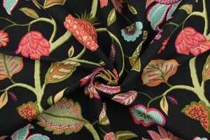 This fabric features a vibrant floral design in green, purple, turquoise, orange, pink, beige, red, and white against a black background. 