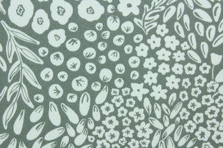 Krisa features a floral and leaf design in white against a pebble gray  background.  It is perfect for any project where the fabric will be exposed to the weather.  Able to resist stains and water, and has a rating of 15,000 double rubs, UV tested and can withstand 500 hours of direct sunlight  Uses include cushions, tablecloths, upholstery projects, decorative pillows and craft projects. This fabric has a slightly stiff feel but is easy to work with.  