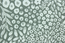 Load image into Gallery viewer,  Krisa features a floral and leaf design in white against a pebble gray  background.  It is perfect for any project where the fabric will be exposed to the weather.  Able to resist stains and water, and has a rating of 15,000 double rubs, UV tested and can withstand 500 hours of direct sunlight  Uses include cushions, tablecloths, upholstery projects, decorative pillows and craft projects. This fabric has a slightly stiff feel but is easy to work with.  
