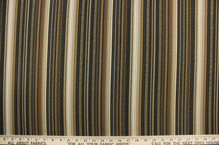 This rich woven yarn dyed fabric features bold multi width striped pattern in black, gold, cream, beige, tan, and bronze. 