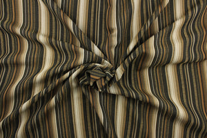 This rich woven yarn dyed fabric features bold multi width striped pattern in black, gold, cream, beige, tan, and bronze. 