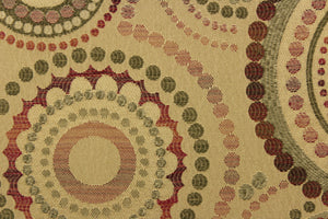 This contemporary geometric design features overlapping circles and dots in red, beige, green, brown, and burgundy.