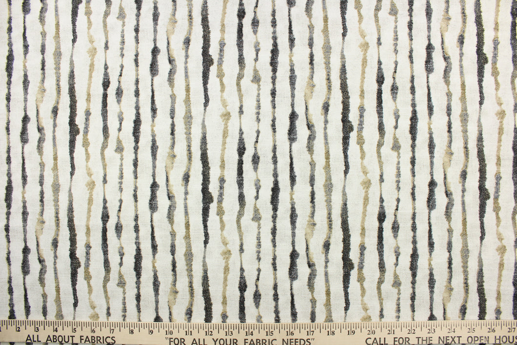 This fabric features a stripe design in black, gray, taupe, and white