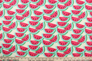 This fabric features a watermelon design in rich pink, light blue, black, and green against a dull white background . 