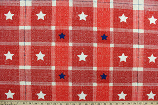 This screen printed fabric features a gingham design featuring blue and white stars.  It is perfect for any project where the fabric will be exposed to the weather.  Able to resist stains and water, and has a rating of 10,000 double rubs, UV tested and can withstand 500 hours of direct sunlight  Uses include cushions, tablecloths, upholstery projects, decorative pillows and craft projects. This fabric has a slightly stiff feel but is easy to work with.  Colors include red, white and blue.