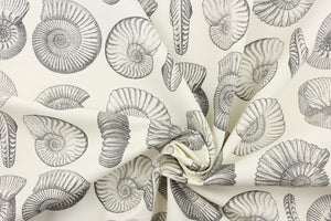 This fabric features a seashell design in gray and black against a dull white . 