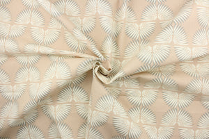 This contemporary screen printed fabric features a caterpillar in gray and white against a pale pink or nude background. 