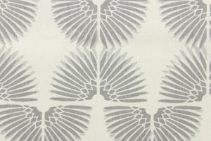 This contemporary screen printed fabric features a caterpillar in varying shades of gray against a white background. 