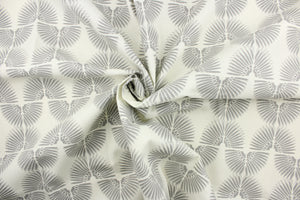 This contemporary screen printed fabric features a caterpillar in varying shades of gray against a white background. 